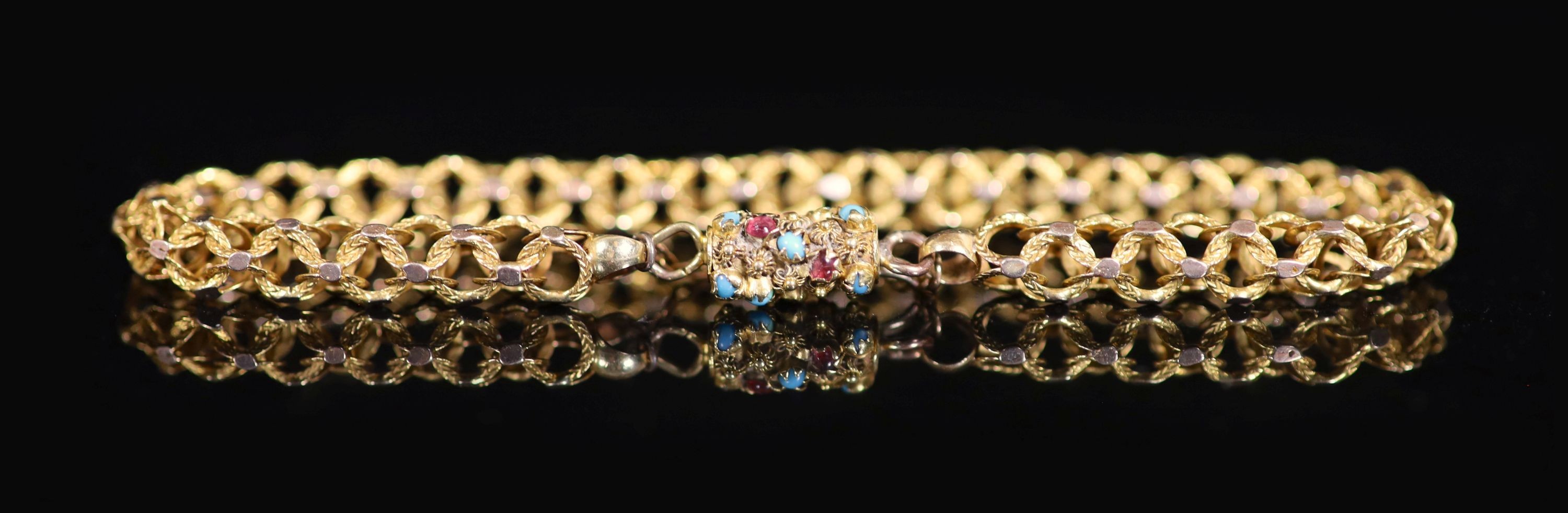 A 19th century gold triple ring link bracelet, with cabochon turquoise and garnet set barrel shaped clasp
